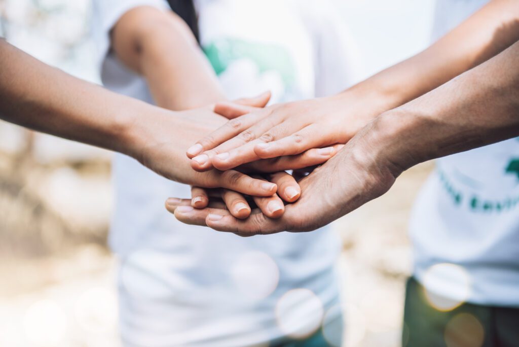 Close up of people volunteer teamwork putting hands together,Stack of hands,Unity and teamwork